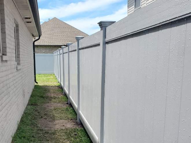 Gray Embossed Vinyl Privacy Fence in Lakeland Style from Country Estate with Federated Post Caps. (Marrero)