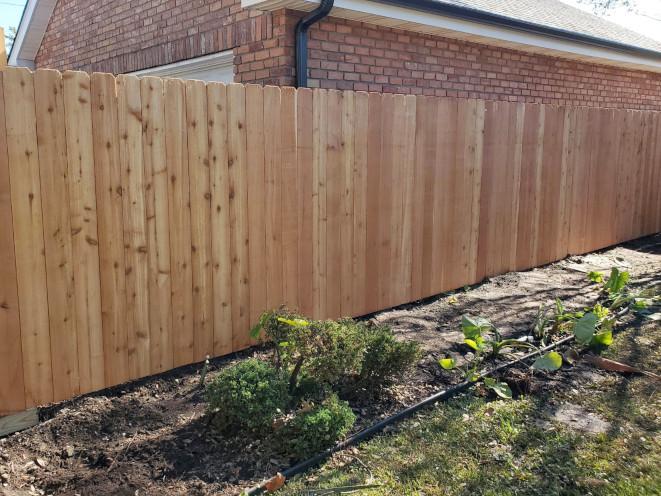 6' high cedar fence with commercial grade posts in Kenner, LA. It is a 2-stringer constructed fence.