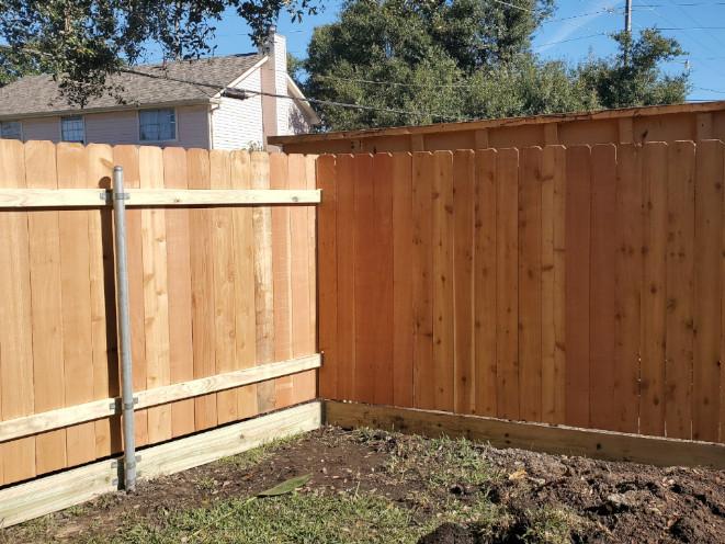 6' high cedar fence with a 2" x 8" pressure-treated pine mud boards. Customer requested higher fence installation.