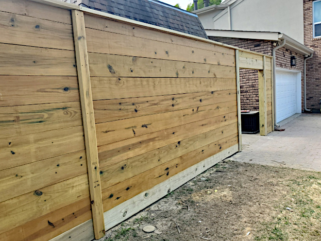8' High Pine Horizontal Fence with top cap and slats covering where boards connect.