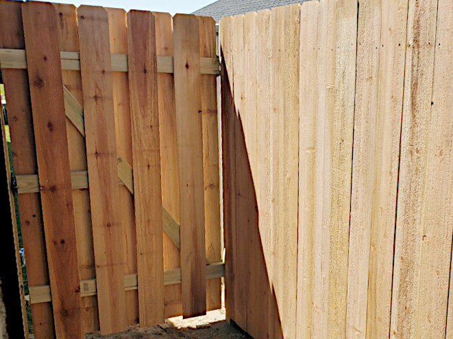Shadowbox cedar gate with overlap between the fence boards. Installed in Marrero, LA.