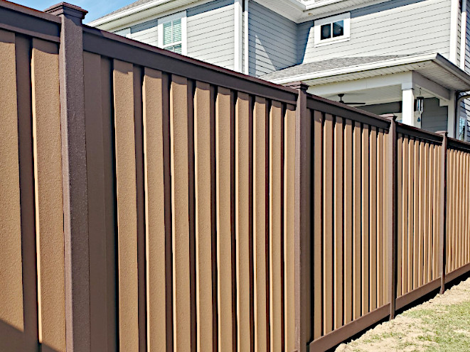 Trex vertical Seclusions composite fence in two brown colored-tone panels. Installed in New Orleans, LA.