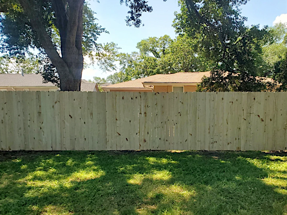 6' high pine dog-ear fence, 3 stringers (runners) with one 4' wide aluminum personnel gate. Installed in the Filmore neighborhood.