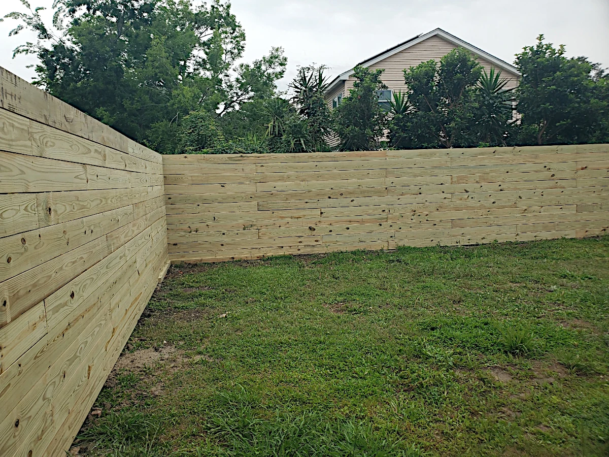 7' high pine horizontal fence using 1" x 8" planks. Planks are not feather-edged. In the Gentilly area, right by City Park.