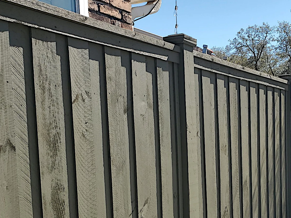 6' board-on-board pine fence in Lakeshore/Lake Vista, New Orleans — suspended between exposed 6" posts with caps, flat top cap, and 12" mudboard at the base.
