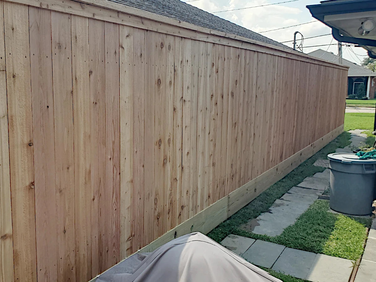 6' high cedar fence with a pressure treated pine mud board installed in Metairie, LA.