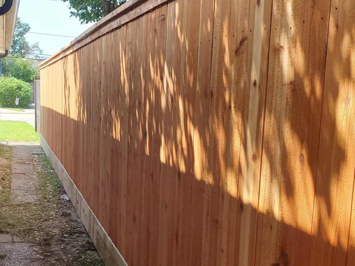 6' high cedar fence with a pressure treated pine mud board installed in Metairie, LA.