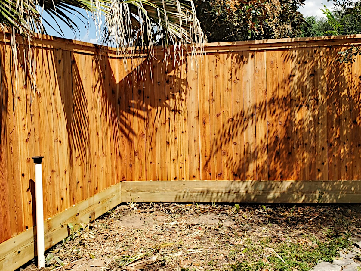6' high cedar fence with a pressure treated pine mud board installed in Metairie, LA.