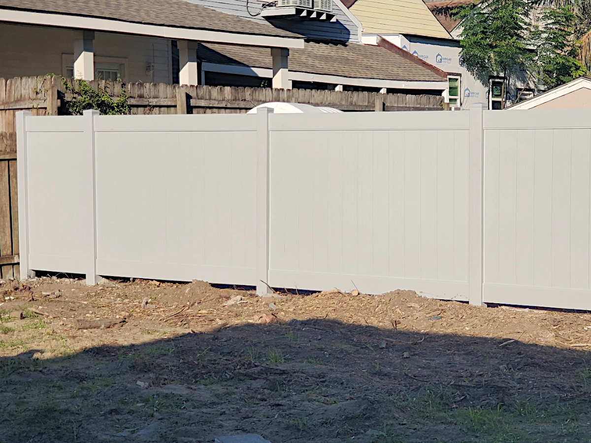 Grey, Vinyl Country Estate privacy fence in the Lakeland series. Installed in New Orleans.