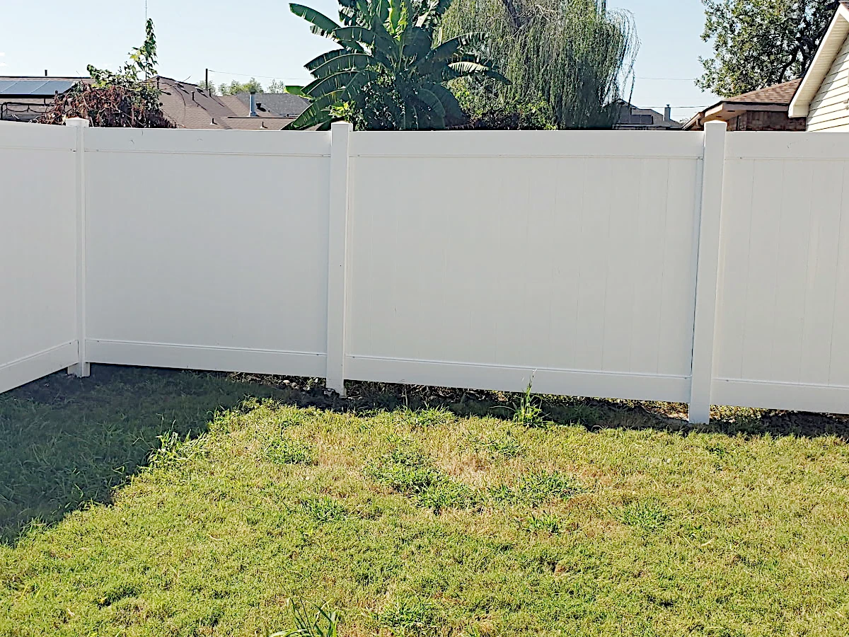 6-foot-high white Country Estate vinyl fence with standard flat top post caps, 2-rail. Lakeland series.