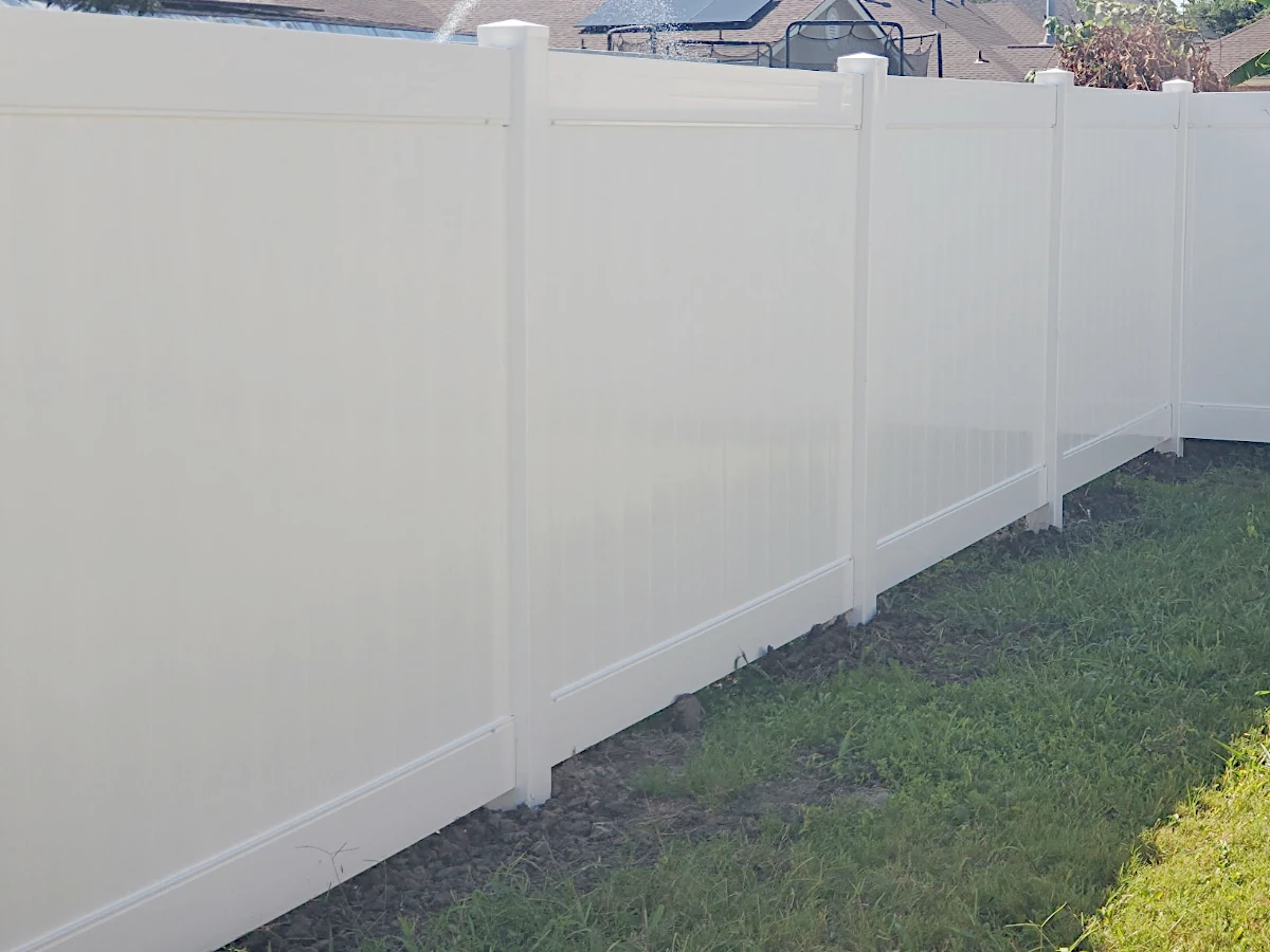 6-foot-high white Country Estate vinyl fence with standard flat top post caps, 2-rail. Lakeland series.